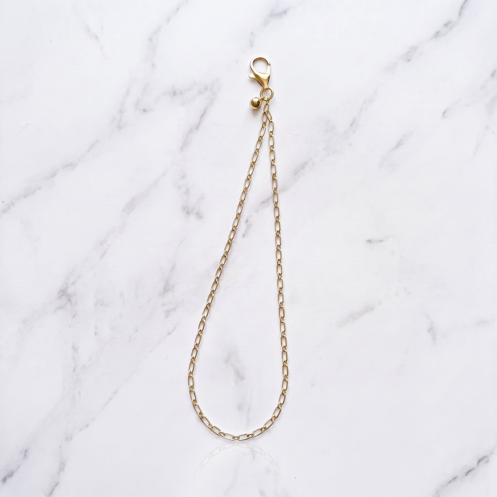 The Golden Drop - Gold Wrist Strap with Ball Charm